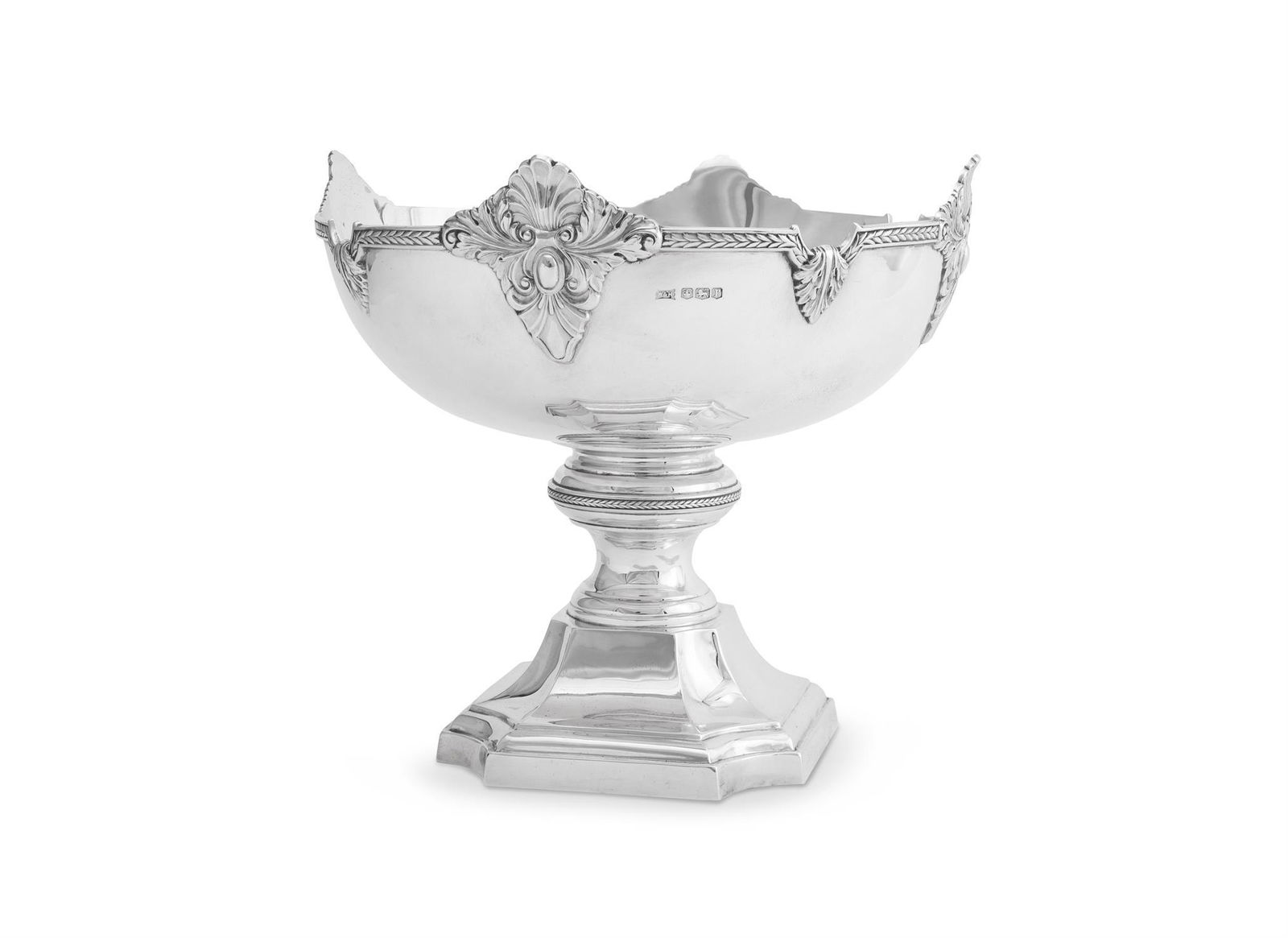 A SILVER SHAPED CIRCULAR PEDESTAL TABLE CENTRE PIECE: A SILVER SHAPED CIRCULAR PEDESTAL TABLE CENTRE PIECEWALKER & HALL, SHEFFIELD 1934With a chased shell and foliate border, a turned stem and on a square pedestal foot with concave corners27cm (10 1/2in)