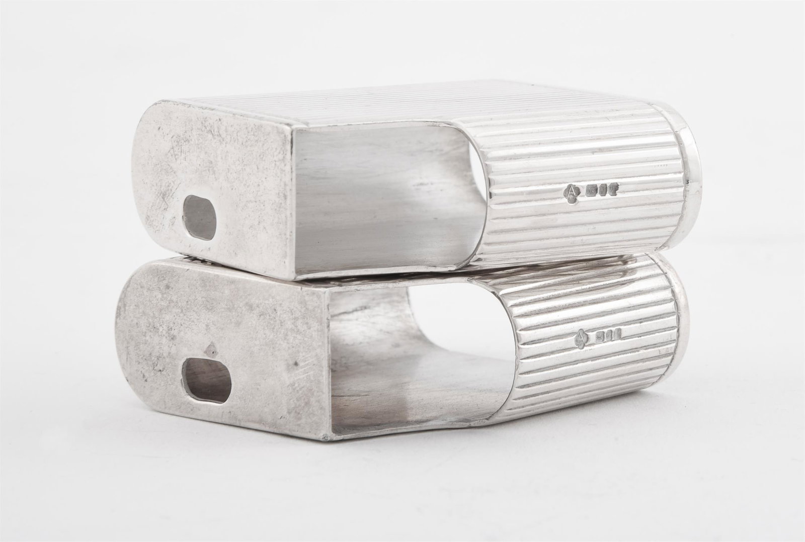 A PAIR OF SILVER GAS LIGHTER COVERS, ASPREY PLC: A PAIR OF SILVER GAS LIGHTER COVERS ASPREY PLC, LONDON 1995With reeded decoration5cm (2in) high97g (3.1 oz)Provenance: from the collection of Victoria, Lady de Rothschild