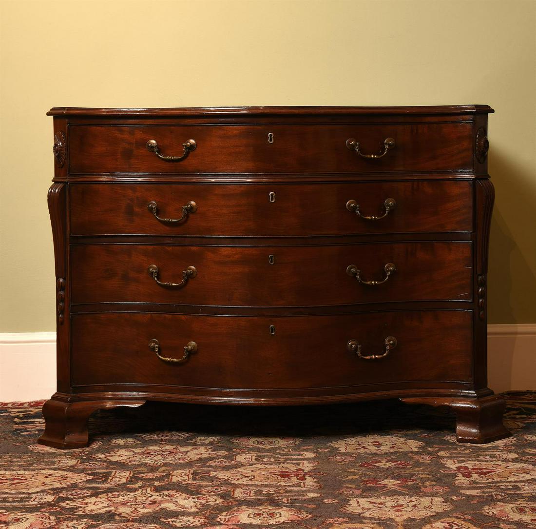 A GEORGE III MAHOGANY SERPENTINE COMMODE, IN THE MANNER OF THOMAS CHIPPENDALE, CIRCA 1770: A GEORGE III MAHOGANY SERPENTINE COMMODE IN THE MANNER OF THOMAS CHIPPENDALE, CIRCA 1770 The top drawer fitted with a tooled leather inset slide84cm high, 113cm wide, 56cm deep