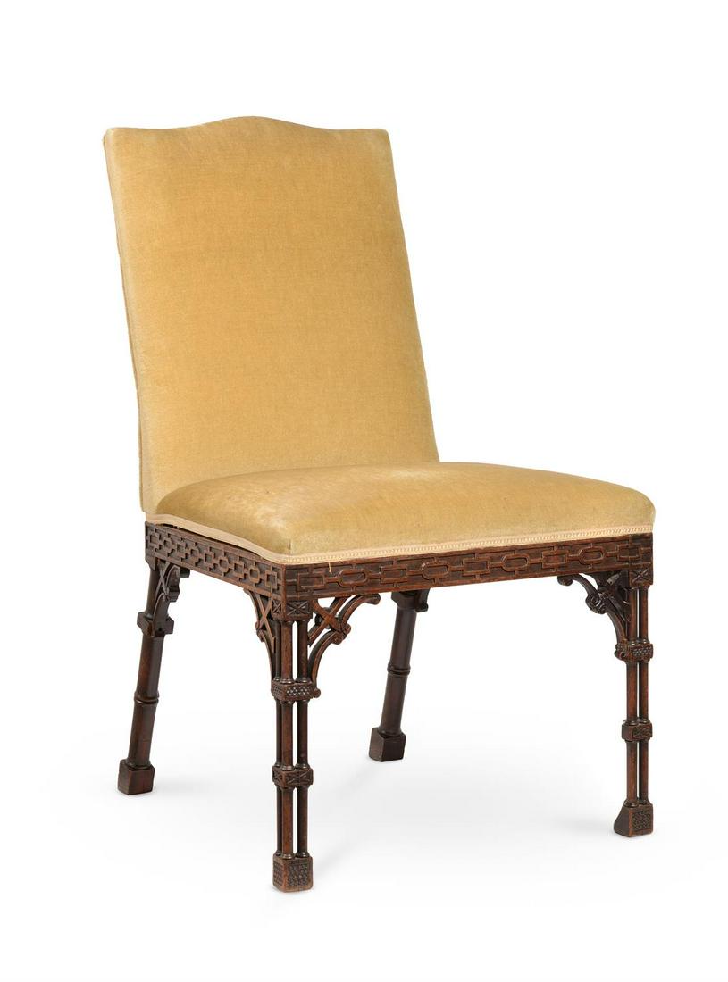 A GEORGE III CARVED MAHOGANY AND UPHOLSTERED SIDE CHAIR, IN THE MANNER OF THOMAS CHIPPENDALE: A GEORGE III CARVED MAHOGANY AND UPHOLSTERED SIDE CHAIRIN THE MANNER OF THOMAS CHIPPENDALE, CIRCA 1770The arched back above a blind fretwork frieze and cluster legs97cm high