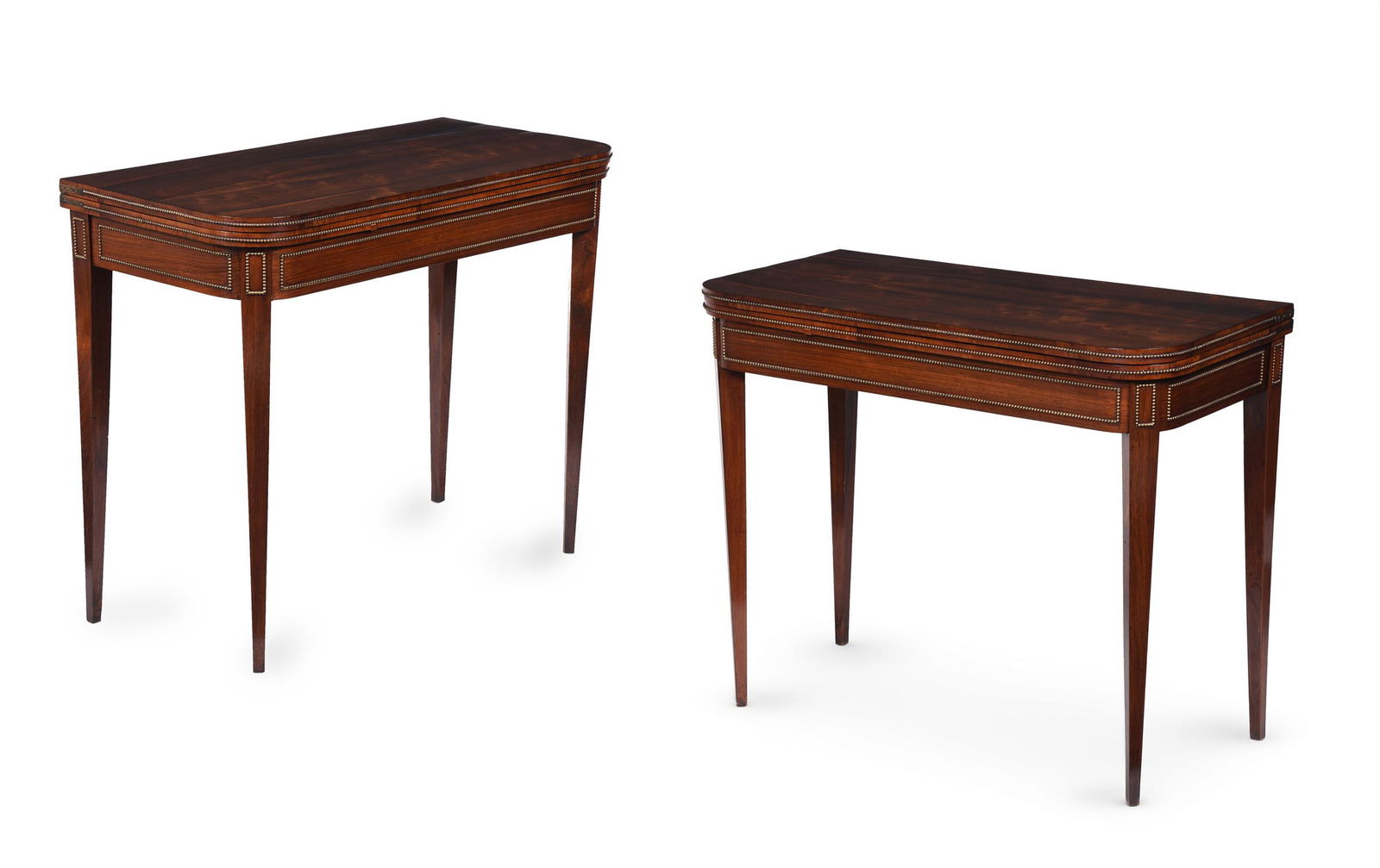 Y A PAIR OF REGENCY ROSEWOOD AND SIMULATED ROSEWOOD FOLDING CARD TABLES, IN THE MANNER OF JOHN: Y A PAIR OF REGENCY ROSEWOOD AND SIMULATED ROSEWOOD FOLDING CARD TABLES IN THE MANNER OF JOHN MCLEAN, CIRCA 1815Both with gilt metal mounts to the edge of the top and friezeeach 76cm high, 92cm wide,
