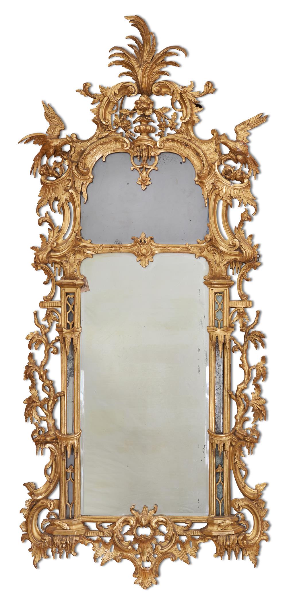 A CARVED GILTWOOD MIRROR, LATE 18TH/ EARLY 19TH CENTURY: A CARVED GILTWOOD MIRROR LATE 18TH/ EARLY 19TH CENTURY, IN THE MANNER OF THOMAS CHIPPENDALE with divided bevelled arched rectangular plate,carved overall with scrolling foliage, acanthus scrolls and f