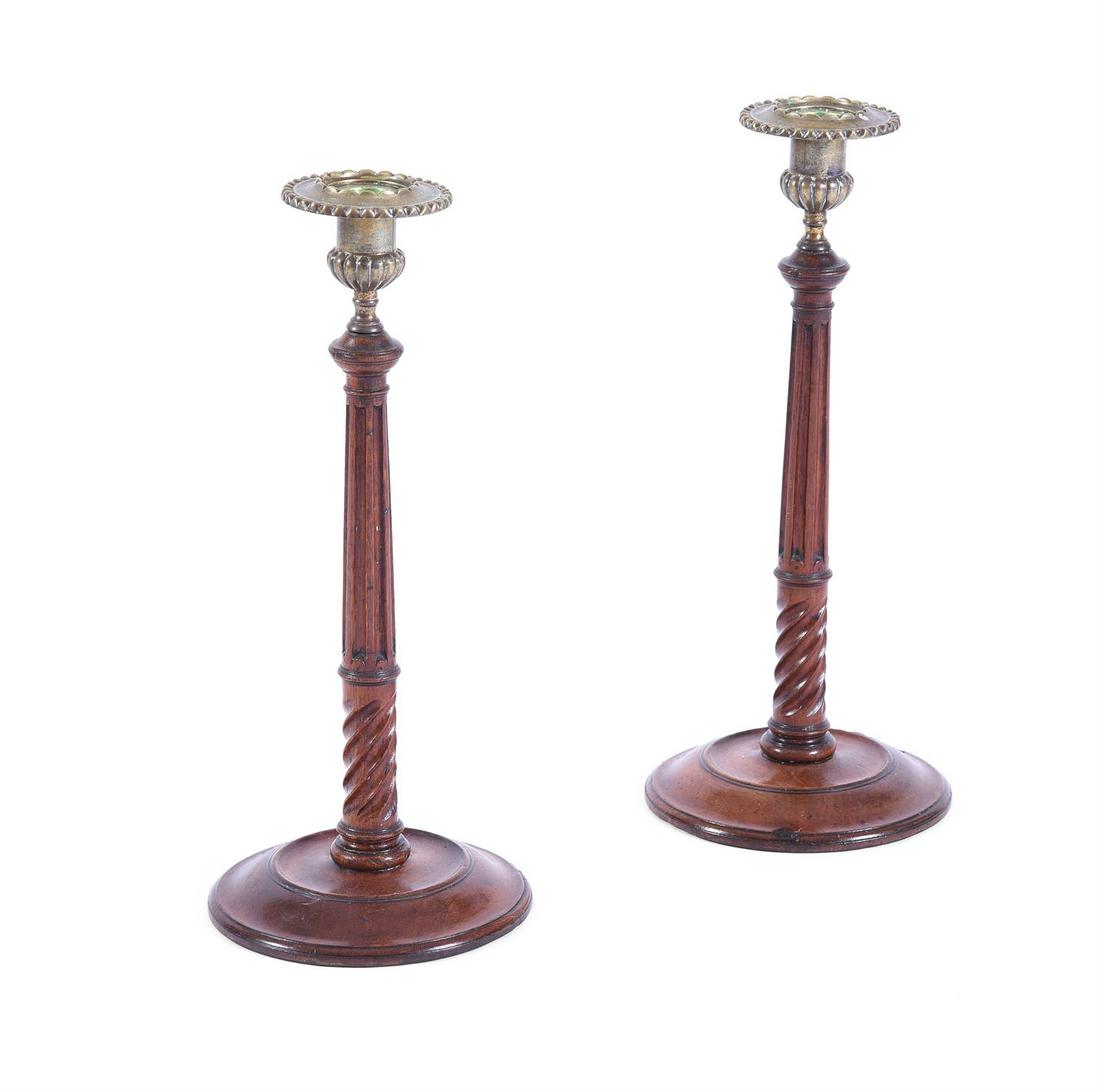 A PAIR OF GEORGE III MAHOGANY CANDLESTICKS, POSSIBLY SCOTTISH: A PAIR OF GEORGE III MAHOGANY CANDLESTICKSPOSSIBLY SCOTTISH, LATE 18TH CENTURY each 33cm high, the base 14cm dimeter
