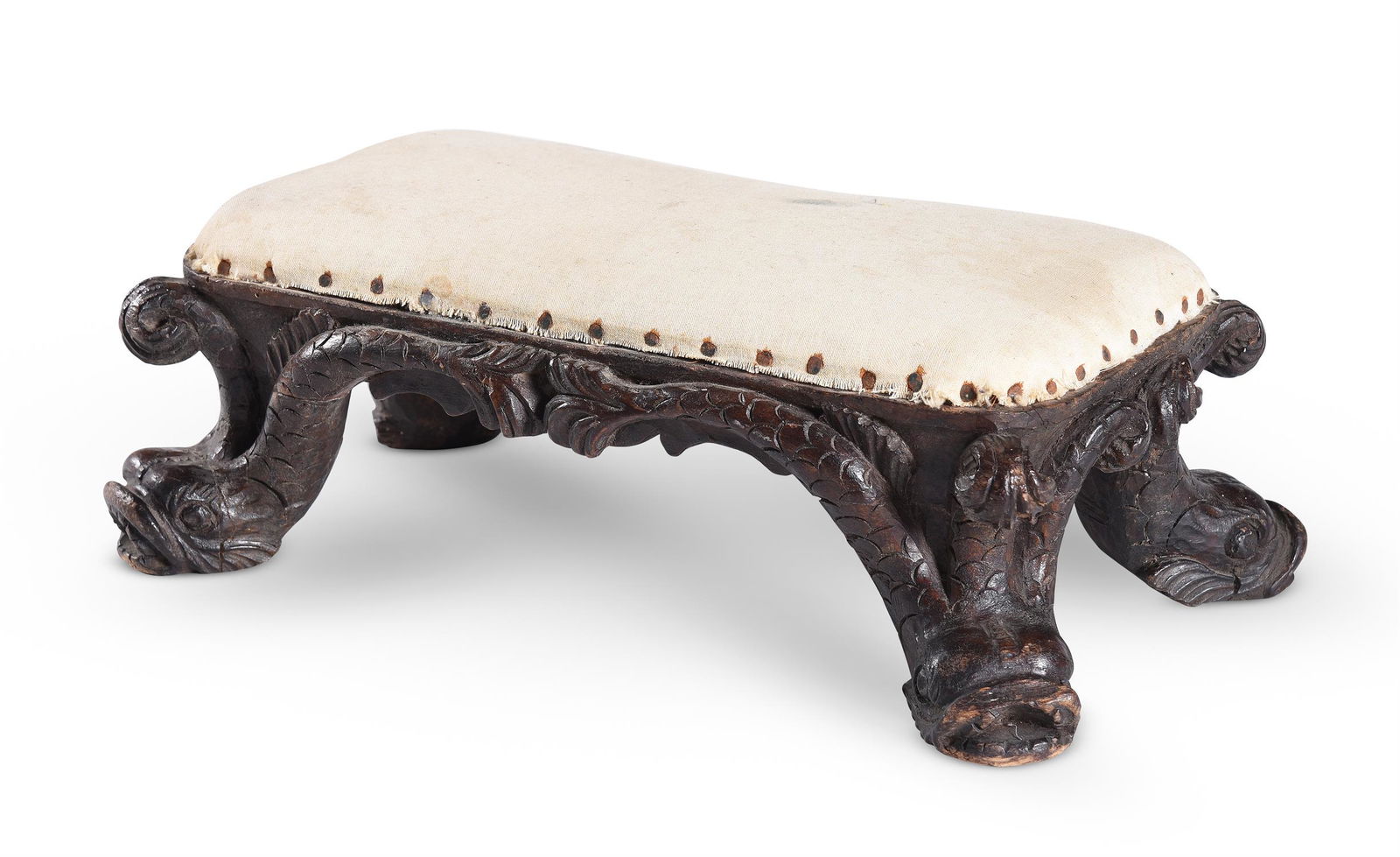 A SMALL CARVED BEECH STOOL, IN THE MANNER OF WILLIAM KENT, 18TH OR EARLY 19TH CENTURY: A SMALL CARVED BEECH STOOL IN THE MANNER OF WILLIAM KENT, 18TH OR EARLY 19TH CENTURYCarved with dolphins 15cm high, 43cm wide, 24cm deep overallProvenance: Property from the Phillip Lucas Collection,