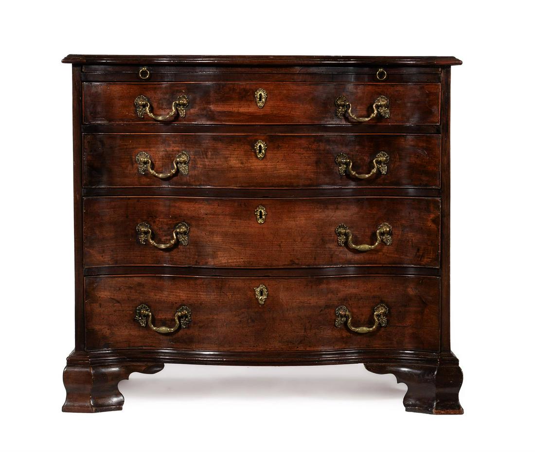 A GEORGE III MAHOGANY AND CROSSBANDED SERPENTINE FRONT COMMODE, IN THE MANNER OF THOMAS CHIPPENDALE (1 of 5)