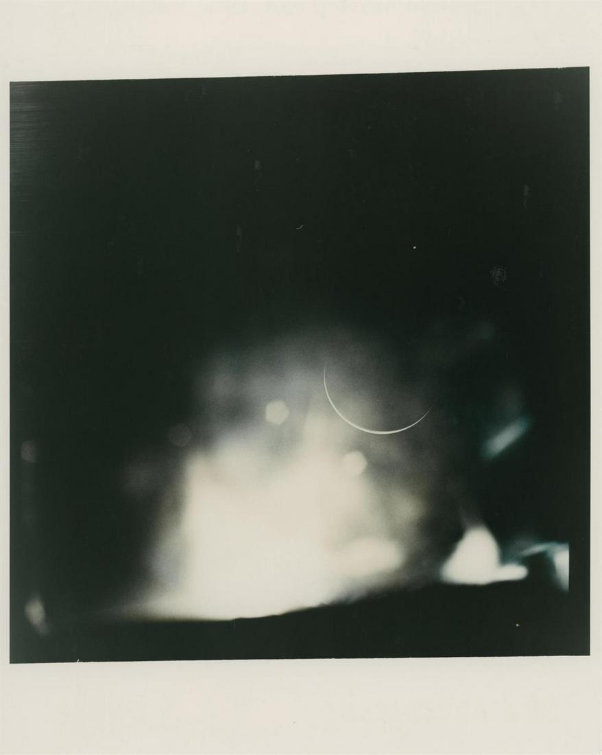 Crescent Earth as seen from deep space, Apollo 15, 26 July - 7 August 1971: Alfred Worden, James Irwin or David Scott A view of a very thin sliver of Earth disc from deep space, barely illuminated by sunlight from the side, with an amazing lens flare effect, Apollo 15, 26 Jul