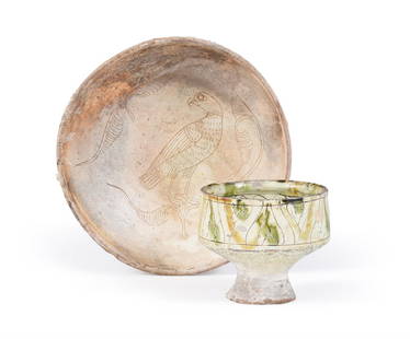 A BYZANTINE CREAM SLIPWARE POTTERY BOWL, CIRCA 12TH CENTURY A.D.: A BYZANTINE CREAM SLIPWARE POTTERY BOWL CIRCA 12TH CENTURY A.D. Decorated with a raptor perched on a stylised branch, sea encrustation on the exterior 8cm high, 25.5cm diameter Together with a