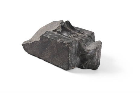 AN EGYPTIAN FRAGMENTARY SCHIST STATUE BASE, LATE PERIOD CIRCA 664-525 B.C.: AN EGYPTIAN FRAGMENTARY SCHIST STATUE BASE LATE PERIOD, CIRCA 664-525 B.C. Carved with the feet of a figure set on an integral rectangular base, the hands of a diminutive worshipper resting on the bas