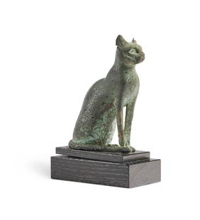 AN EGYPTIAN BRONZE FIGURE OF A SEATED CAT, LATE PERIOD, CIRCA 664-525 B.C: AN EGYPTIAN BRONZE FIGURE OF A SEATED CATLATE PERIOD, CIRCA 664-525 B.CThe tail curled around the haunches and touching the right forepawmounted, 12cm highProvenance:Christie's East, New York, 11 May