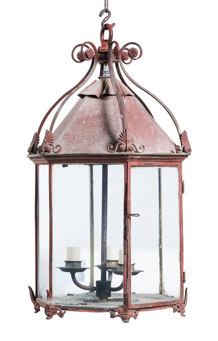 A REGENCY RED PAINTED TOLE LANTERN, EARLY 19TH CENTURY: A REGENCY RED PAINTED TOLE LANTERN EARLY 19TH CENTURY Scrolling crest above glazed hexagonal body, with feet for table use and suspension ring for hanging, later fitted for electricity 65cm high, 37cm