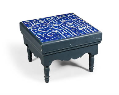 AN EBONISED LOW TABLE INSET WITH ISLAMIC TILES, THE TILES 17TH CENTURY SAFAVID PERSIAN: AN EBONISED LOW TABLE INSET WITH ISLAMIC TILES THE TILES 17TH CENTURY SAFAVID PERSIAN44cm high, 64cm wide, 62cm deep Saleroom notice: Bidders are advised that some countries prohibit or restrict the i