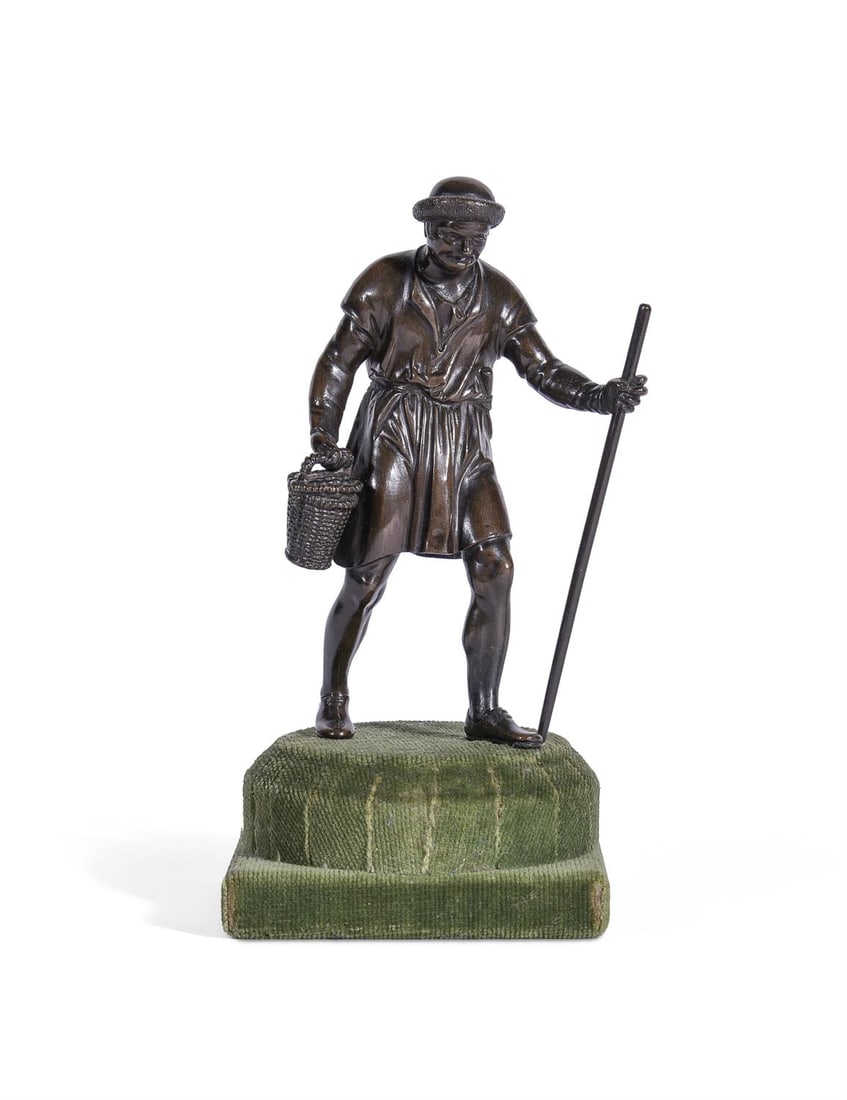 BARTHÉLEMY PRIEUR (C.1536-1611) A BRONZE FIGURE OF A PEASANT ITALIAN: BARTHÉLEMY PRIEUR (C.1536-1611) A BRONZE FIGURE OF A PEASANT ITALIAN, EARLY 17TH CENTURY Carrying a wicker basket and holding a staff, now set on green velvet covered base figure 13.5cm high, 17.