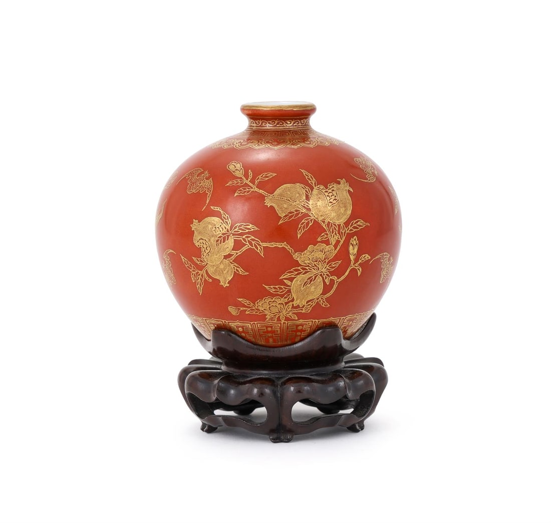 A Chinese coral-ground 'Three Abundances' waterpot: A Chinese coral-ground 'Three Abundances' waterpot, Guangxu, potted with a spherical body rising to a short neck with a slightly beaded mouth rim, decorated to the body in gilding with peaches, pomegr