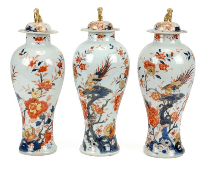 A suite of three Chinese Imari vases and covers, e: A suite of three Chinese Imari vases and covers, each of inverted baluster form with cylindrical neck, the shallow domed covers each with a Buddhist lion knop, decorated in typical palette with a gold