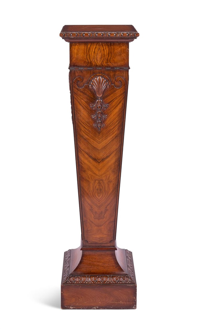 A WALNUT PEDESTAL IN THE MANNER OF WILLIAM KENT, LATE 19TH CENTURY: A WALNUT PEDESTAL IN THE MANNER OF WILLIAM KENT LATE 19TH CENTURY Shell and bellflower carved decoration 112.5cm high, top 30.5cm square