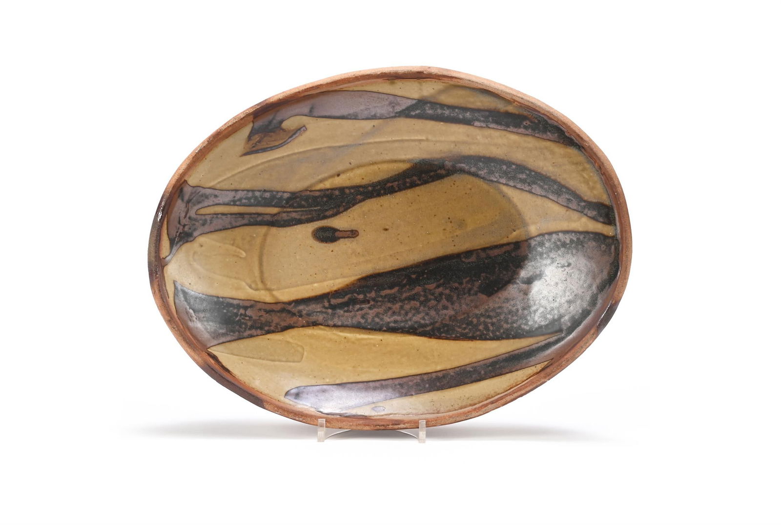 λ MICHAEL CARDEW (BRITISH 1901-1983); OVAL DISH: λ MICHAEL CARDEW (BRITISH 1901-1983)OVAL DISHCeramic with brown and ochre glazesImpressed maker's 'MC' mark and Wenford Bridge Pottery seal (to underside)27 x 36cm (10½ x 14 in.) λ indi