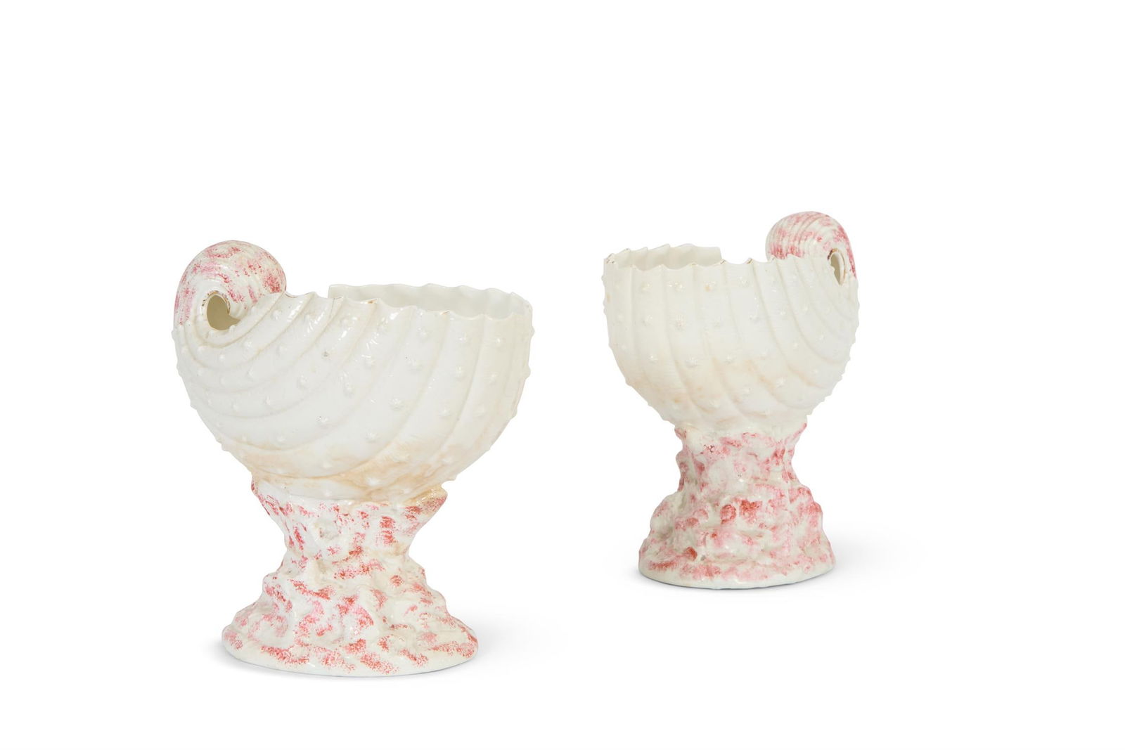 A PAIR OF POTTERY VASES MODELLED AS NAUTILUS SHELLS, ENGLISH, THIRD QUARTER 19TH CENTURY: A PAIR OF POTTERY VASES MODELLED AS NAUTILUS SHELLSENGLISH, THIRD QUARTER 19TH CENTURYPartially decorated in pink, 26cm high