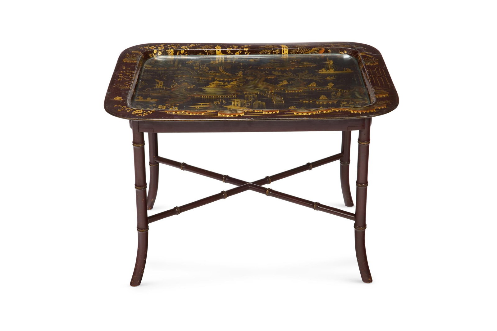 A REGENCY PAPIER MACHE AND GILT-JAPANNED TRAY IN THE MANNER OF HENRY CLAY: A REGENCY PAPIER MACHE AND GILT-JAPANNED TRAY IN THE MANNER OF HENRY CLAY, EARLY 19TH CENTURY Decorated with landscapes, pagodas and sail boats on an associated simulated bamboo stand 43cm high, 62cm