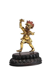 A Sino-Tibetan gilt bronze figure of Simhavaktra: A Sino-Tibetan gilt bronze figure of Simhavaktra, 18th century, the boar headed Buddhist goddess holding a vajra in her raised right hand, a skull bowl in her left, with her flaming hair with red pigm