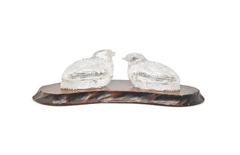 A pair of Chinese rock crystal quail-formed boxes and covers: A pair of Chinese rock crystal quail-formed boxes and covers, Qing Dynasty, each bird 7cm long, wood stand (2)清 水晶鵪鶉蓋盒一對