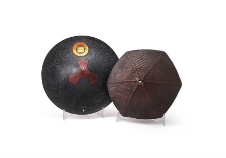 A Japanese Jingasa: A Japanese Jingasa, Late Edo Period, of typical circular form with upturned brim, the textured surface lacquered black with a gilt mon to the from, the interior in red lacquer with kirigane, diameter