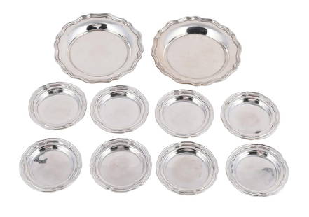A SET OF EIGHT PORTUGUESE SILVER SHAPED CIRCULAR DISHES: A SET OF EIGHT PORTUGUESE SILVER SHAPED CIRCULAR DISHES