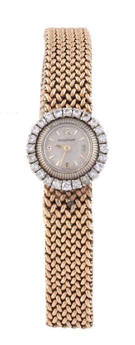 Jaeger LeCoultre, a lady's 18 carat gold and diamo: Jaeger LeCoultre, a lady's 18 carat gold and diamond cocktail watch, circa 1958, ref. 283, the two piece case with a brilliant cut diamond set serrated bezel, the matt silver dial with baton numerals