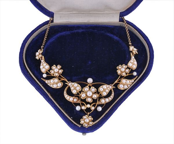 An Edwardian half pearl and bouton pearl necklace,: An Edwardian half pearl and bouton pearl necklace, circa 1910, the central scroll shaped foliate section set with bouton pearls and half pearls, with similarly set articulated foliate connections to a