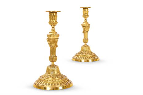 A PAIR OF ORMOLU CANDLESTICKS, FRENCH: A PAIR OF ORMOLU CANDLESTICKS FRENCH, LATE 18TH CENTURY 25cm high, 13cm diameter