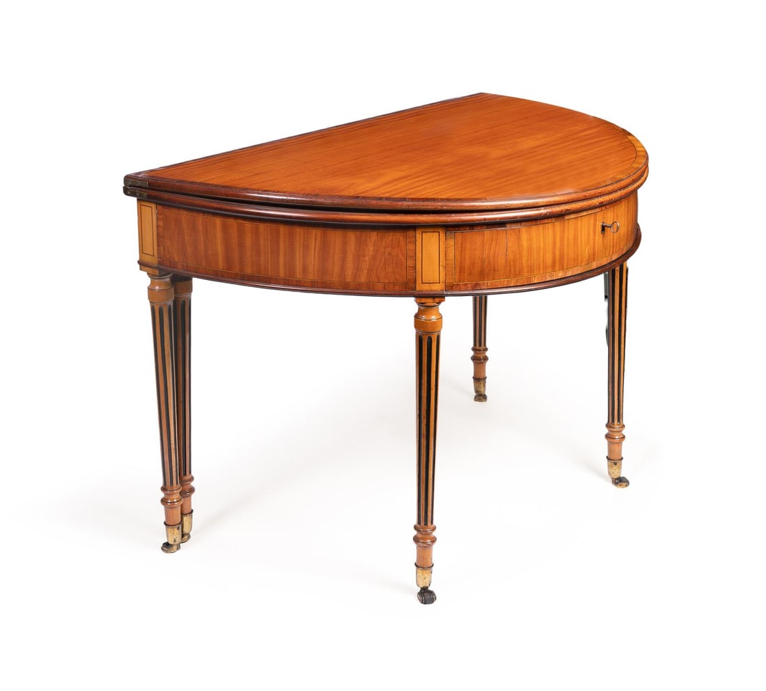 Y A SATINWOOD, TULIPWOOD CROSSBANDED, BEECH, LINE INLAID AND EBONISED FOLDING TEA TABLE: Y A SATINWOOD, TULIPWOOD CROSSBANDED, BEECH, LINE INLAID AND EBONISED FOLDING TEA TABLEPOSSIBLY ANGLO-DUTCH, LATE 18TH CENTURYOf D-shaped outline73cm high, 101cm wide, 65cm deep (when closed)Provenanc