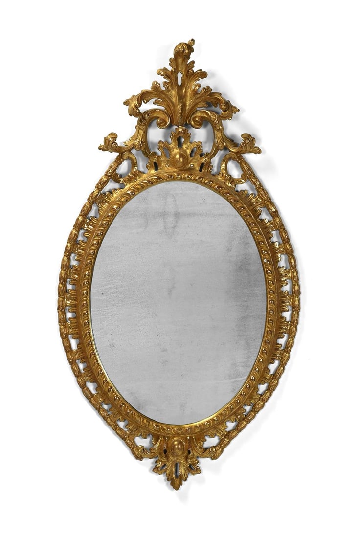 A FINE GEORGE III CARVED GILTWOOD OVAL MIRROR, IN THE MANNER OF THOMAS CHIPPENDALE, CIRCA 1770: A FINE GEORGE III CARVED GILTWOOD OVAL MIRRORIN THE MANNER OF THOMAS CHIPPENDALE, CIRCA 1770115cm high, 62cm wide, 7cm deepProvenance:An Important Private CollectionFor a closely related mirror suppli