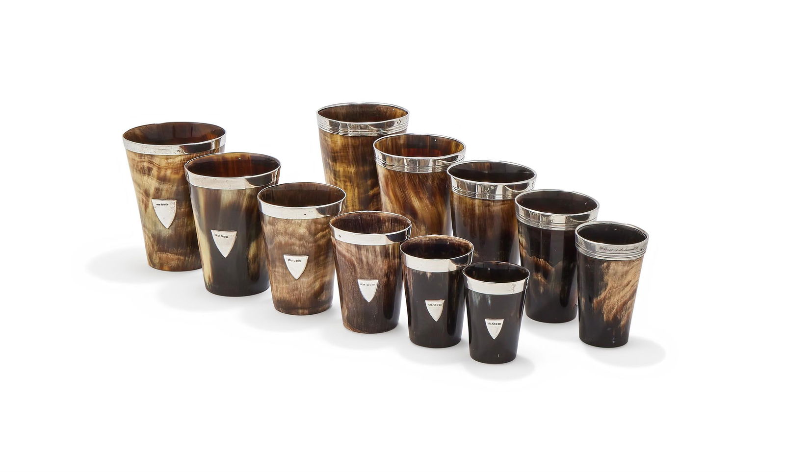 ELEVEN HORN NESTING BEAKERS: ELEVEN HORN NESTING BEAKERSWITH LATE VICTORIAN SILVER RIM MOUNTSFive by Thomas Johnson I, London 1872 (4) and 1873 (1), retailed by F. West, 1 St. James's St., engraved with a crest, the shortest 8cm