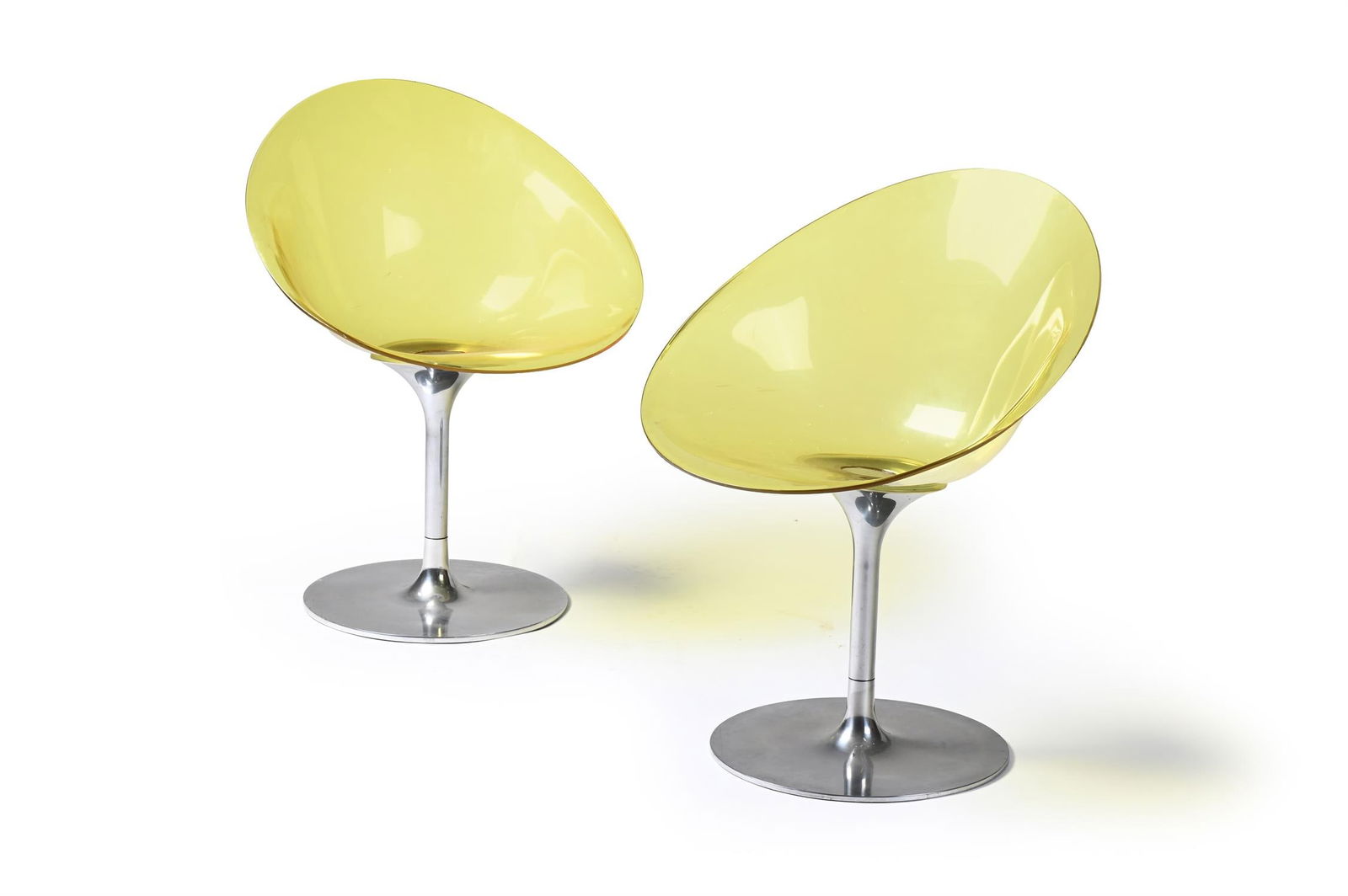 PHILIPPE STARCK (FRENCH, B.1949), A PAIR OF YELLOW-TINTED 'EROS' SWIVEL CHAIRS: PHILIPPE STARCK (FRENCH, B.1949)A PAIR OF YELLOW-TINTED 'EROS' SWIVEL CHAIRS; MADE BY KARTELL; EARLY 21ST CENTURYLucite plastic, polished aluminiumEtched manufacturer's mark 'EROS by Kartell with S+AR