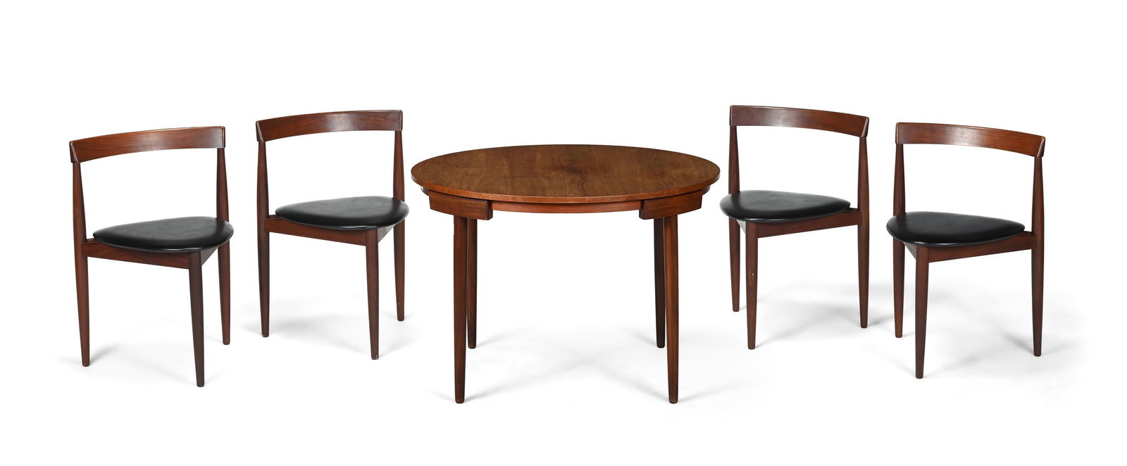 HANS OLSEN (DANISH, 1919-1992), A CIRCULAR DINING TABLE AND FOUR CHAIRS; MID-20TH CENTURY: HANS OLSEN (DANISH, 1919-1992)A CIRCULAR DINING TABLE AND FOUR CHAIRS; MID-20TH CENTURYTeak, black leatherMade by Frem Rojle, Denmark. Stamped to underside of chairs 'FREM ROJLE/MADE IN DENMARK', with