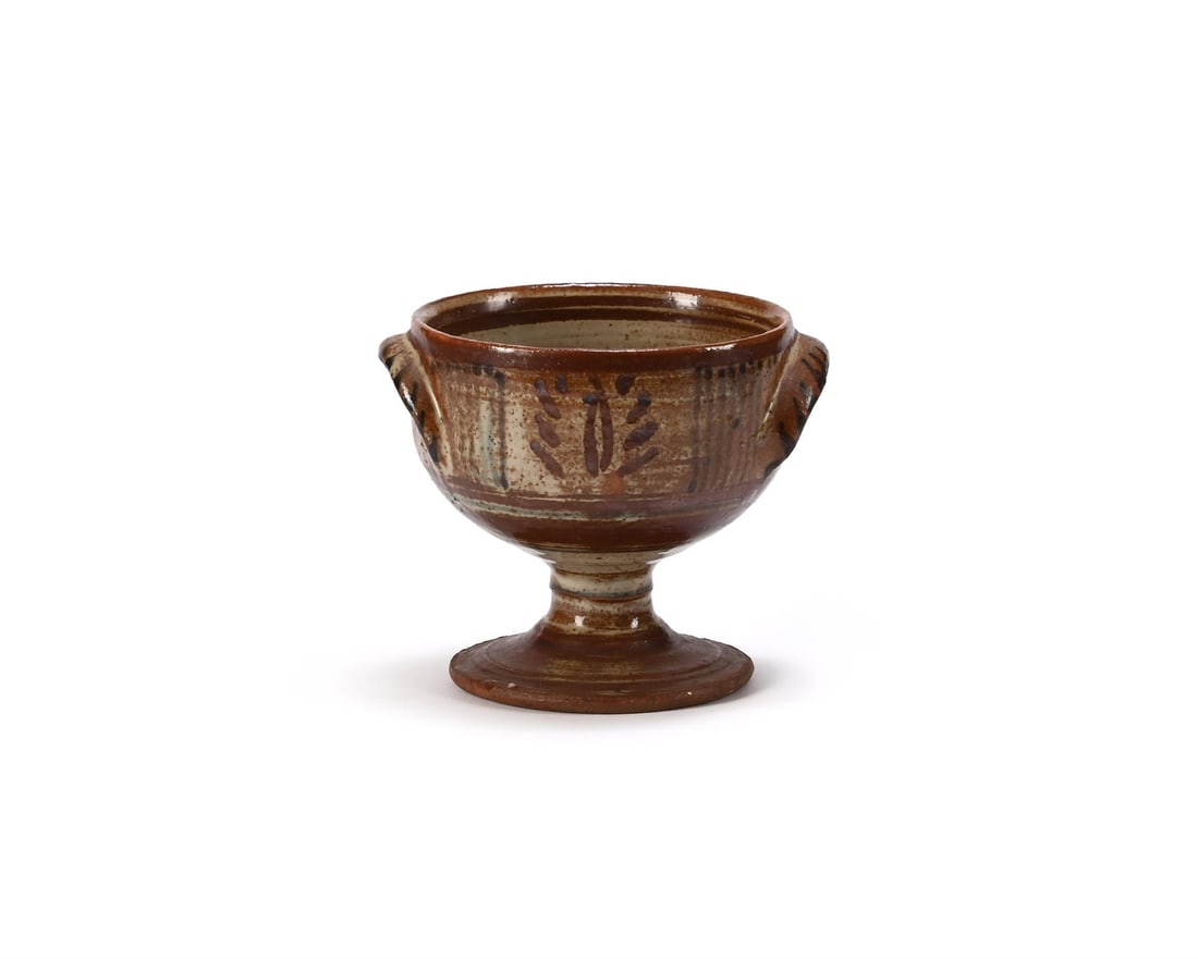 λ MICHAEL CARDEW (BRITISH, 1901-1983), TWIN-HANDLED PEDESTAL BOWL: λ MICHAEL CARDEW (BRITISH, 1901-1983)TWIN-HANDLED PEDESTAL BOWLStoneware with cream and brown iron glazesImpressed maker's 'MC' mark and Wenford Bridge Pottery seal (to underside)13cm high,15.5cm