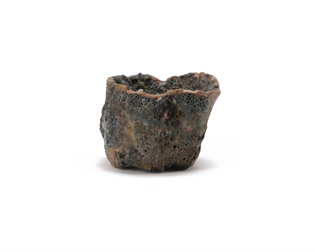 λ EWEN HENDERSON (BRITISH, 1934-2000), TEA BOWL: λ EWEN HENDERSON (BRITISH, 1934-2000)TEA BOWLMixed laminated clays, with black volcanic glaze. 8.5cm high,12cm wide (3¼ x 4½ in.) λ indicates that this lot may be subject to Droit