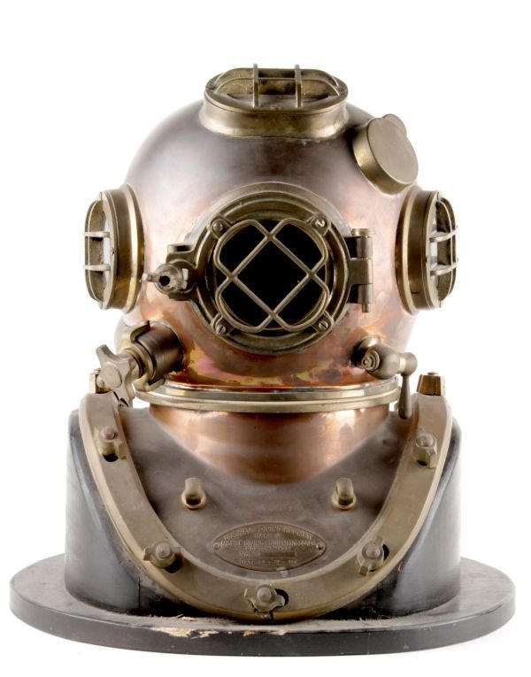 A Morse Diving Equipment Co. copper and brass twel: A Morse Diving Equipment Co. copper and brass twelve-bolt U.S. Navy Diving Helmet, Mark V, with maker's plaque to shoulder plate, dated '8-29-41', 50cm high; together with an ebony handled diver's kni