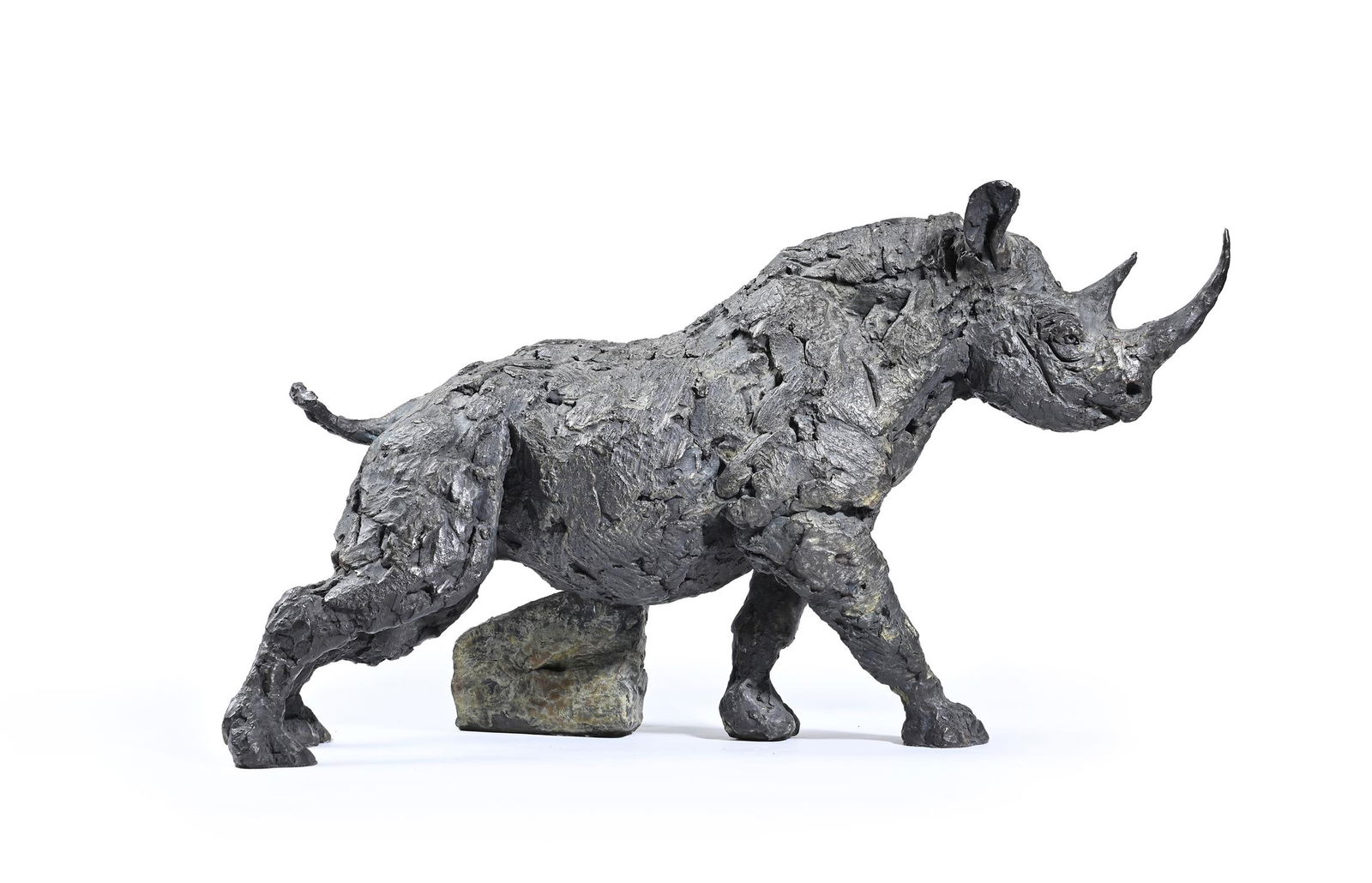 HAMISH MACKIE (BRITISH B. 1973), BLACK RHINO ITCH: HAMISH MACKIE (BRITISH B. 1973)BLACK RHINO ITCHBronzeSigned, dated 2018 and numbered 4/12 30 x 56 x 25.5cm (11¾ x 22 x 10 in.)The rock depicted in this sculpture shows indentations for playing th