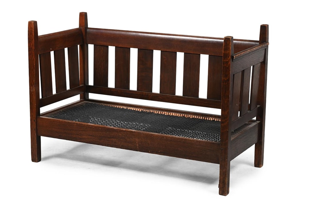 AN ARTS AND CRAFTS OAK SETTLE, POSSIBLY AMERICAN, IN THE MANNER OF THE STICKLEY BROTHERS, CIRCA 1900 (1 of 2)