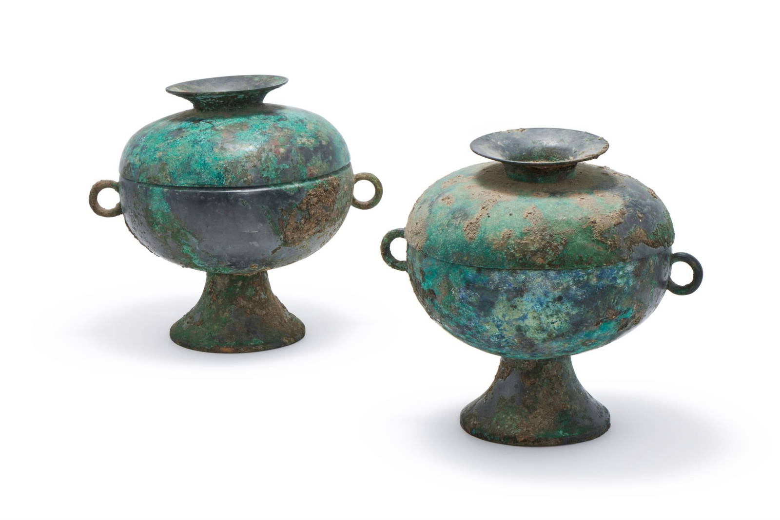 A rare pair of Chinese archaic bronze round vessels and covers