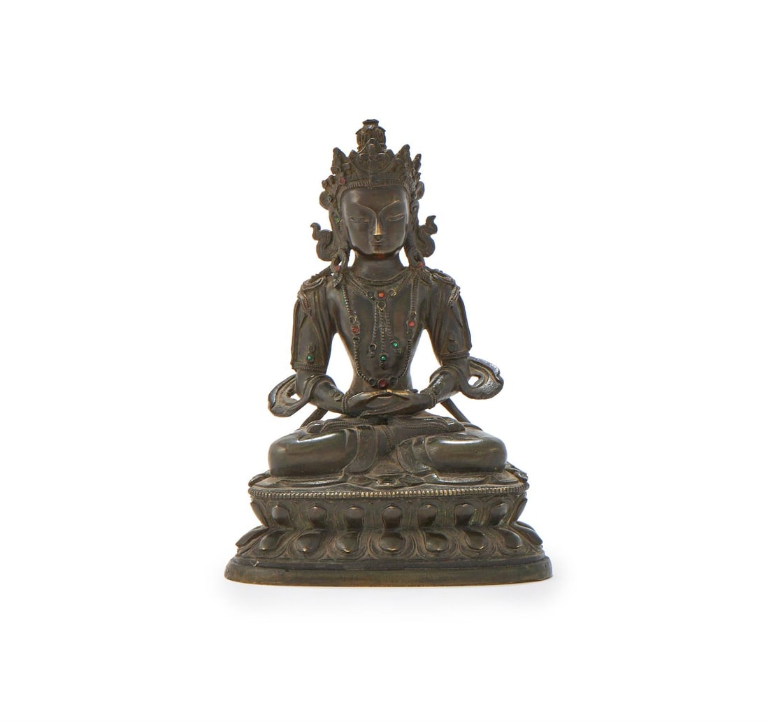 A Sino-Tibetan bronze figure of Amityayus: A Sino-Tibetan bronze figure of Amityayus, 18th century, seated in padmasana on a double lotus throne, his hands in dhyana mudra, wearing coral and malachite inlaid jewellery and elaborate crown with