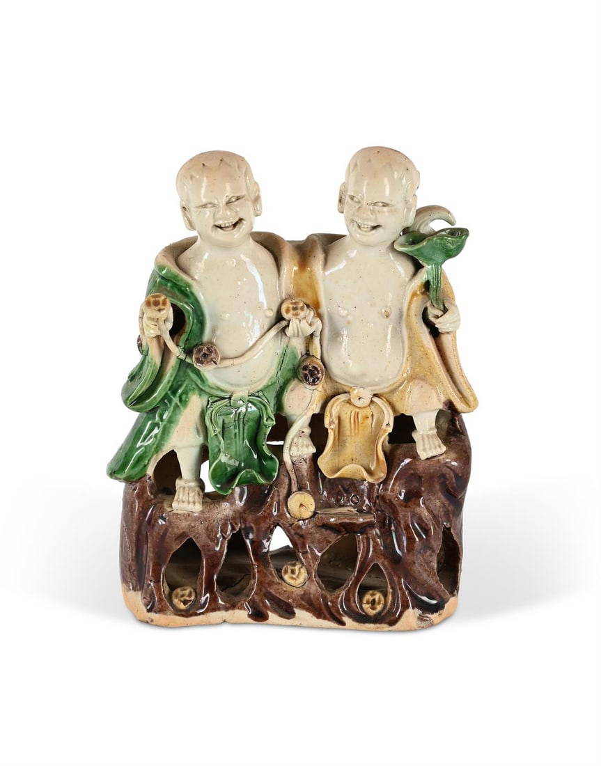 A Chinese Famille Verte biscuit group of the laughing Twins Hehe Erxian