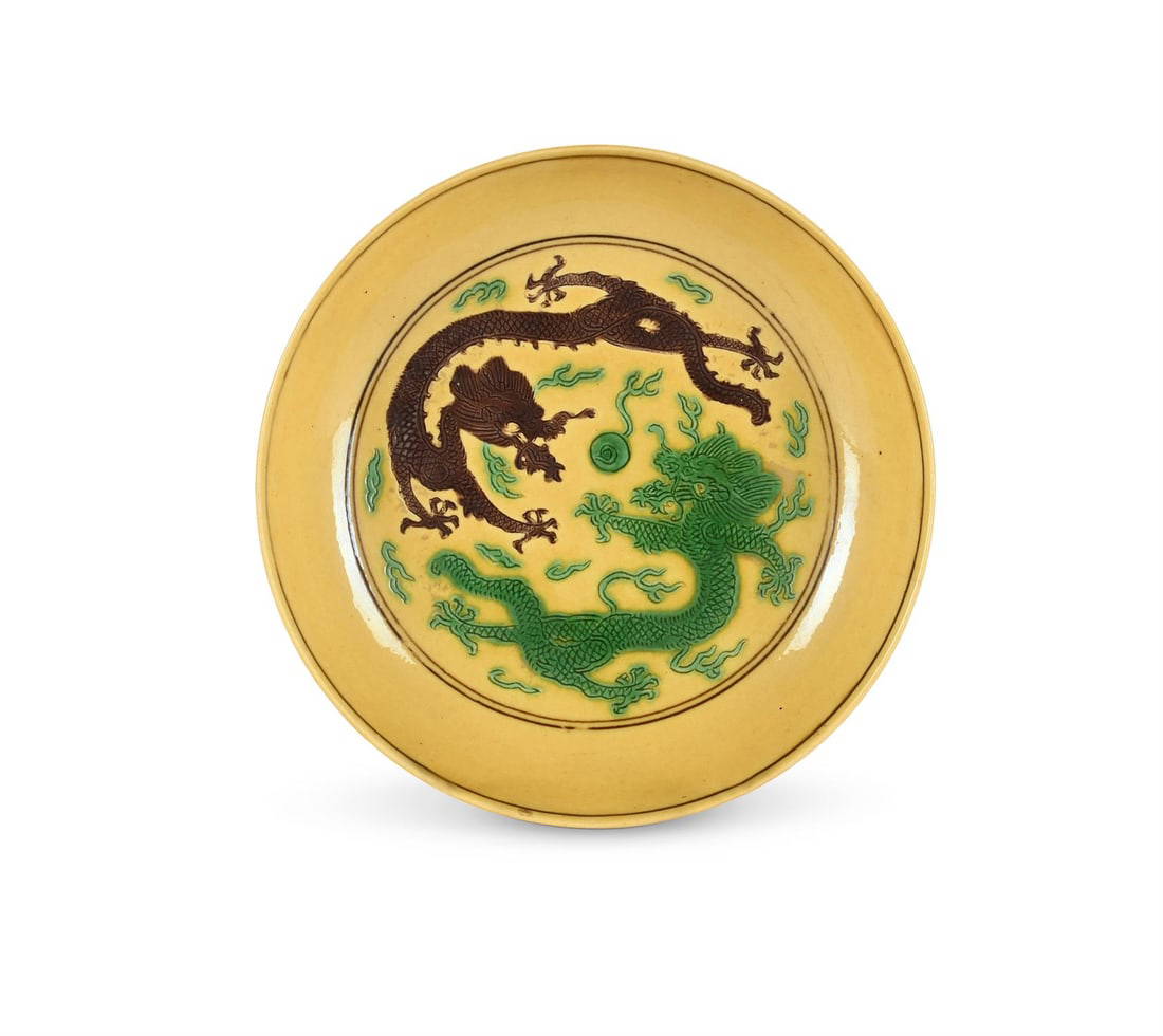 A Chinese Imperial porcelain yellow and green and aubergine-glazed 'dragon' saucer dish