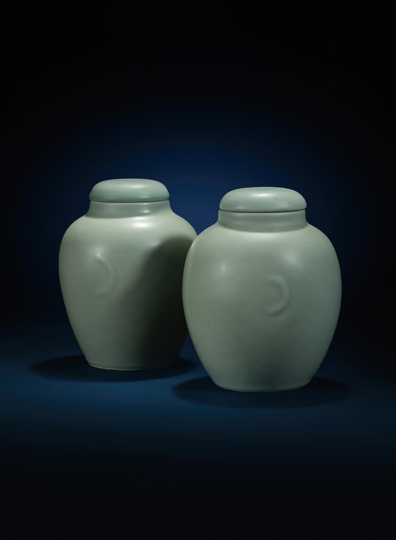 A rare pair of Chinese celadon-glazed jars and covers