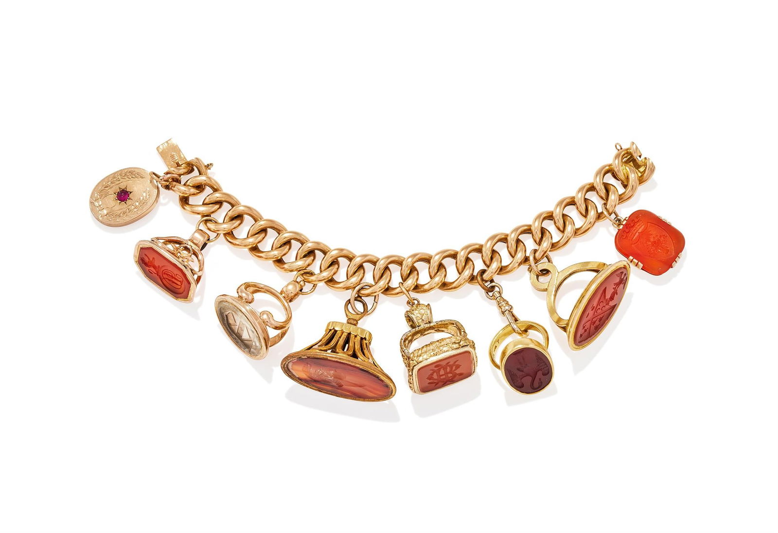A 19TH CENTURY AND LATER FOB SEAL CHARM BRACELET: A 19TH CENTURY AND LATER FOB SEAL CHARM BRACELETThe hollow curb link bracelet suspending a 19th century cabochon ruby set oval locket, with chased foliate wreath detail, and various hardstone fobs, co