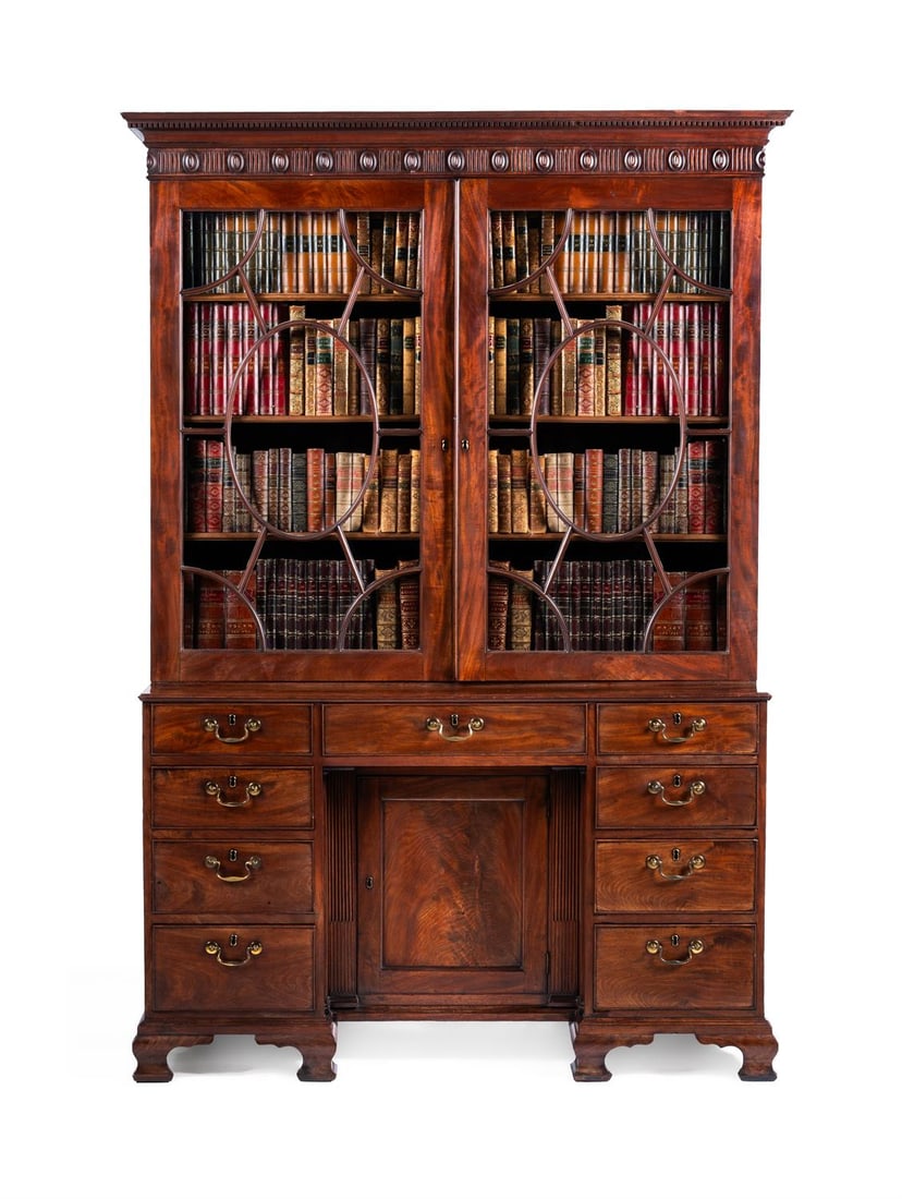 A GEORGE III MAHOGANY BOOKCASE CABINET, IN THE MANNER OF THOMAS CHIPPENDALE, CIRCA 1770: A GEORGE III MAHOGANY BOOKCASE CABINETIN THE MANNER OF THOMAS CHIPPENDALE, CIRCA 1770The glazed doors enclosing adjustable shelves214cm high, 150cm wide, 53cm deep