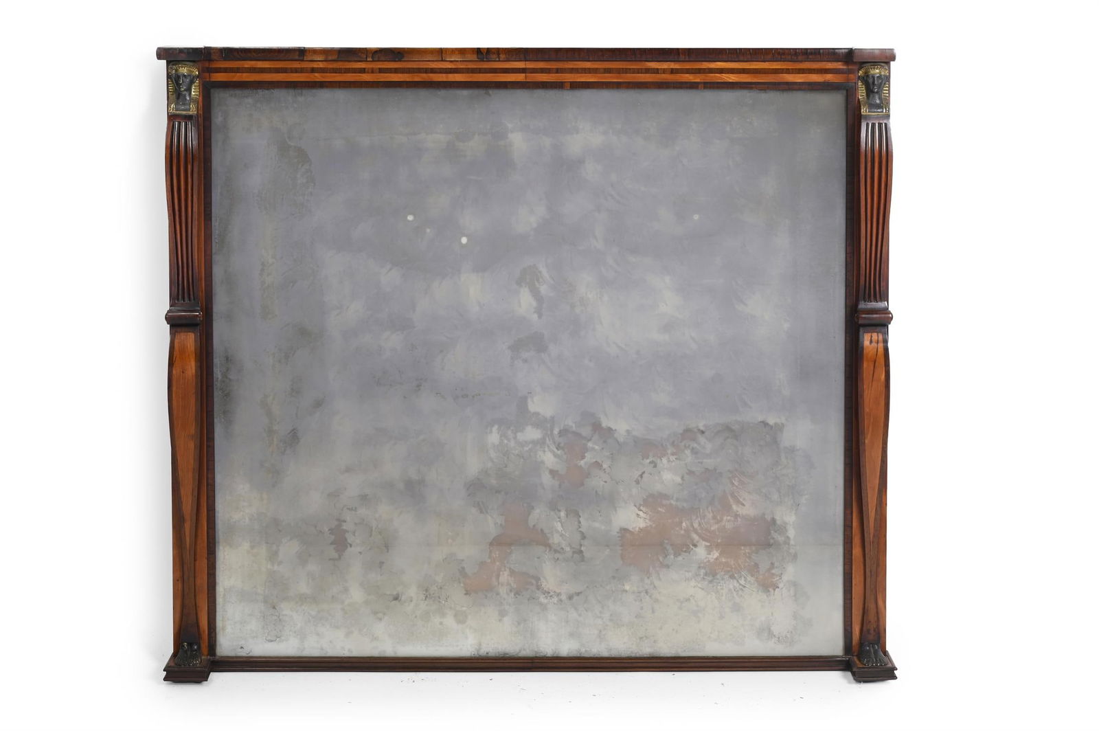 Y A GEORGE III ROSEWOOD, SATINWOOD AND BRASS MOUNTED MIRROR, CIRCA 1810: Y A GEORGE III ROSEWOOD, SATINWOOD AND BRASS MOUNTED MIRRORIN THE MANNER OF THOMAS CHIPPENDALE THE YOUNGER, CIRCA 181094cm high, 106cm wideThe resurgence of interest in the Egyptian taste in the Regen