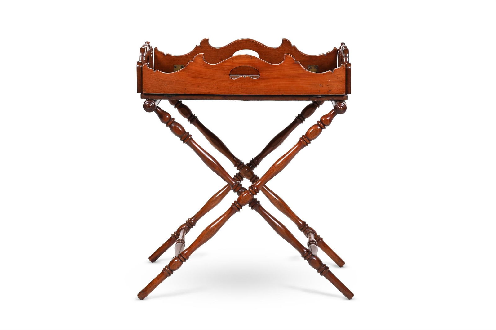 A MAHOGANY BUTLER'S TRAY ON STAND, 19TH CENTURY: A MAHOGANY BUTLER'S TRAY ON STAND19TH CENTURYThe stand ring turned, the tray with brass hinges to the shaped sidesthe tray 15cm high, 95cm wide, 77cm deep (flaps lowered) the stand 71cm high, 67cm wid