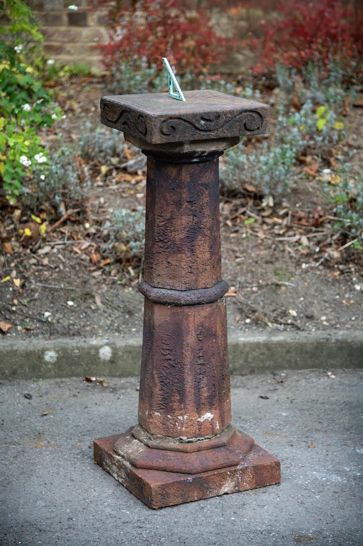 A TERRACOTTA PEDESTAL SUNDIAL, LATE 19TH CENTURY: A TERRACOTTA PEDESTAL SUNDIAL ATTRIBUTED TO ARCHIBALD KNOX FOR COMPTON POTTERY, LATE 19TH CENTURY Bronze gnomon above plate, stylised ram head decoration to sides, unmarked approximately 103cm high ov