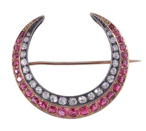 A late Victorian red spinel and diamond crescent b: A late Victorian red spinel and diamond crescent brooch, circa 1900, set with an outer line of graduated cushion shaped red spinels, and an inner line of graduated cushion shaped old cut diamonds, app